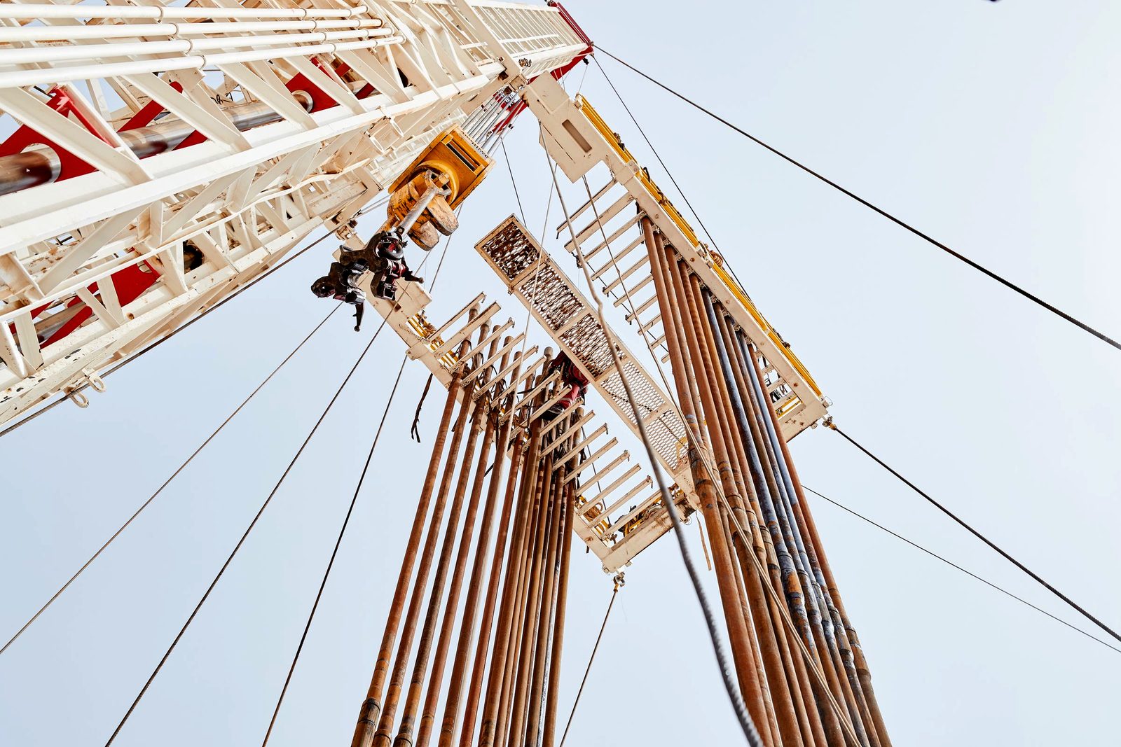 A drilling rig mast raised at an onshore site
