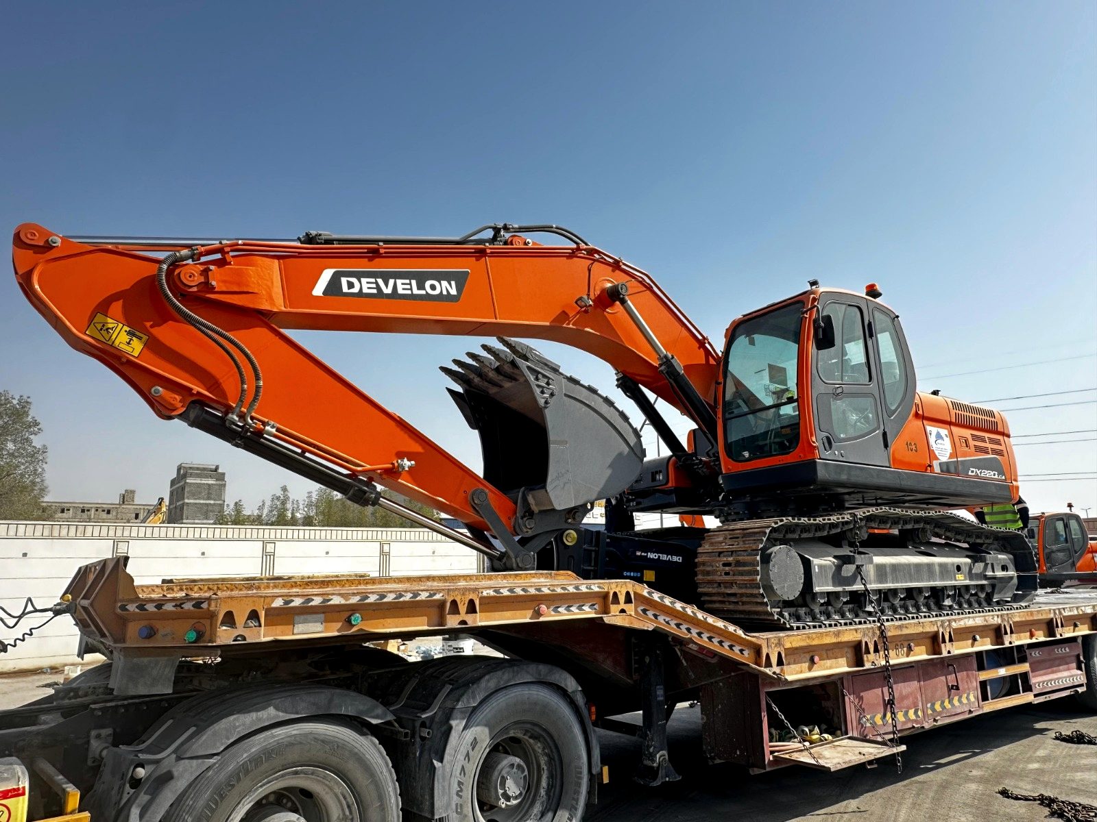 Heavy plant chained down on a RANCO low-bed trailer
