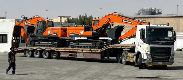 A RANCO prime mover with two tracked machines loaded on a low-bed trailer